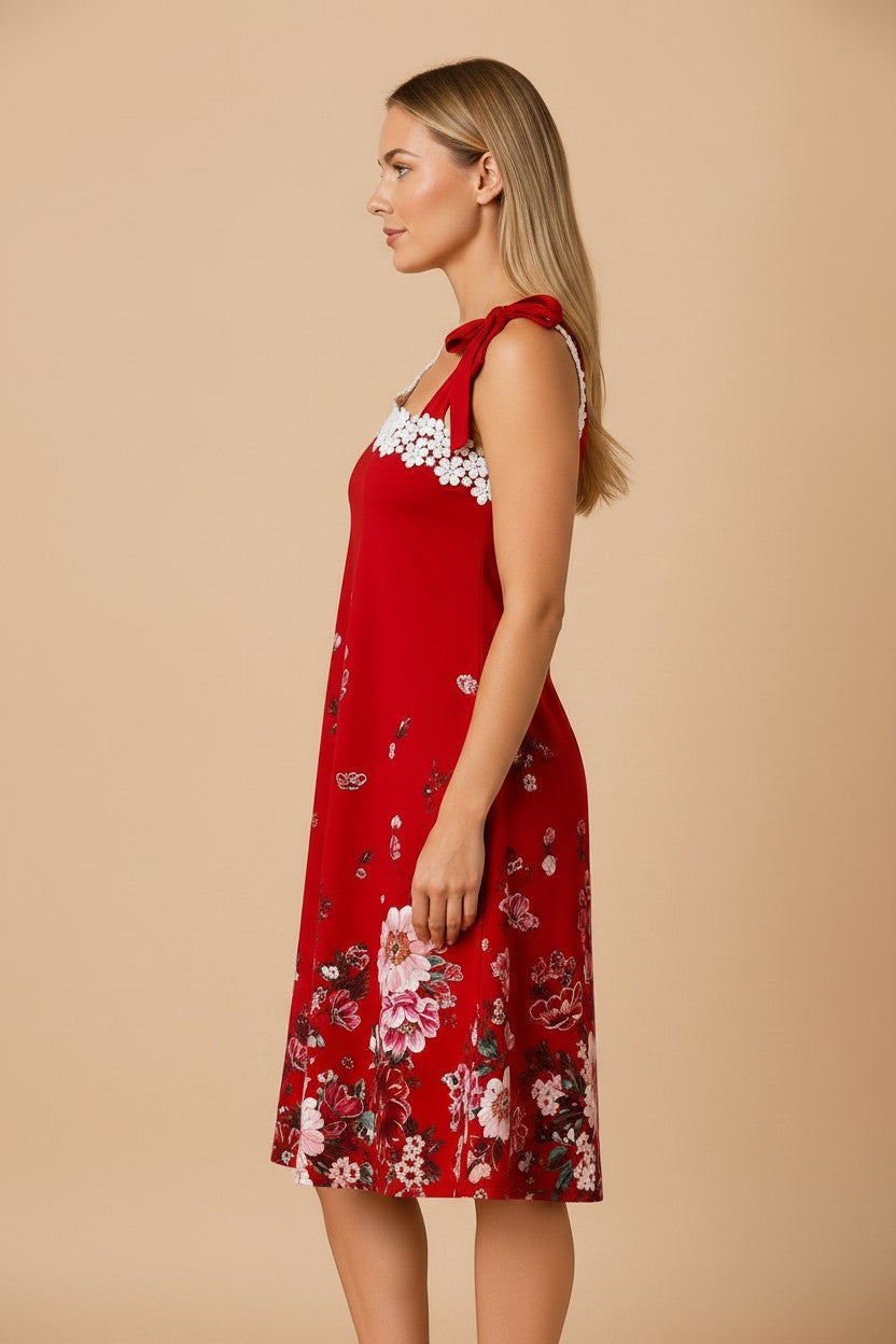 pyjama red floral midi dress with white lace trim and shoulder bow worn by a blonde model in profile