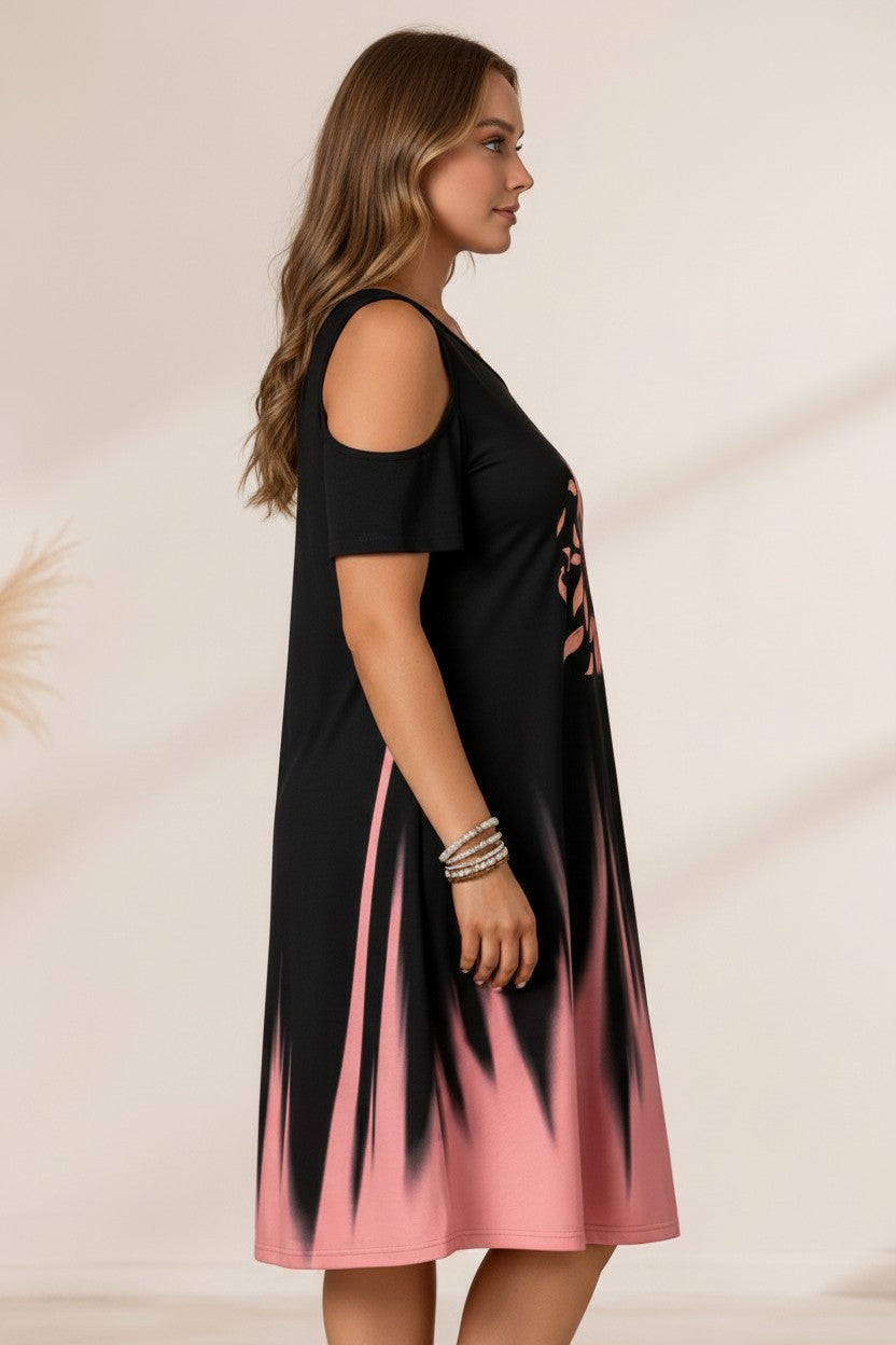 pyjama Sunset Bloom Dress in black with pink ombré and sunflower print, featuring a relaxed cold-shoulder design.