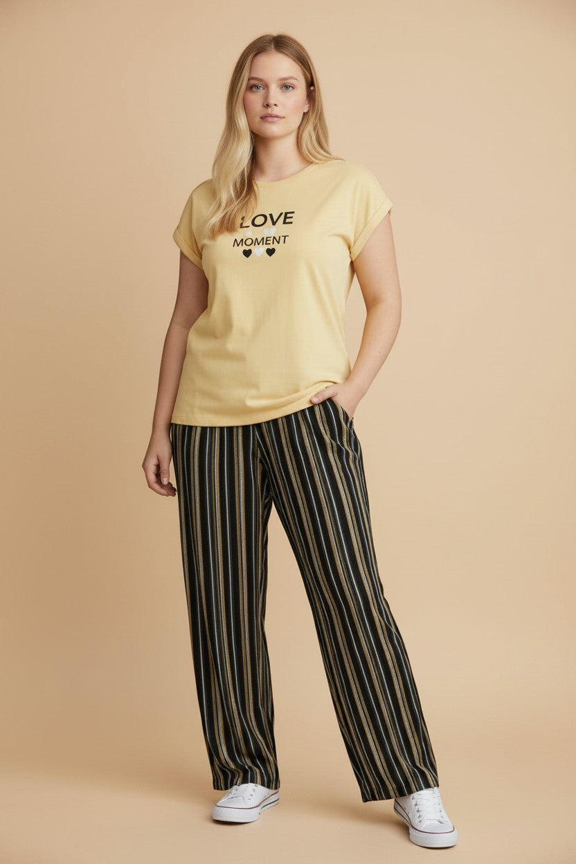 pyjama yellow cotton pajama set with Love Moment graphic tee and black striped trousers worn by a blonde model