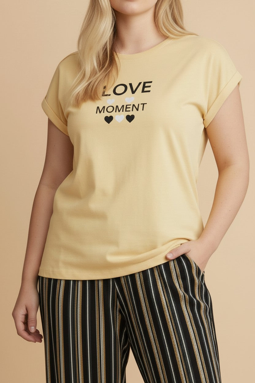 pyjama yellow cotton pajama set with Love Moment graphic t-shirt and striped trousers on a woman
